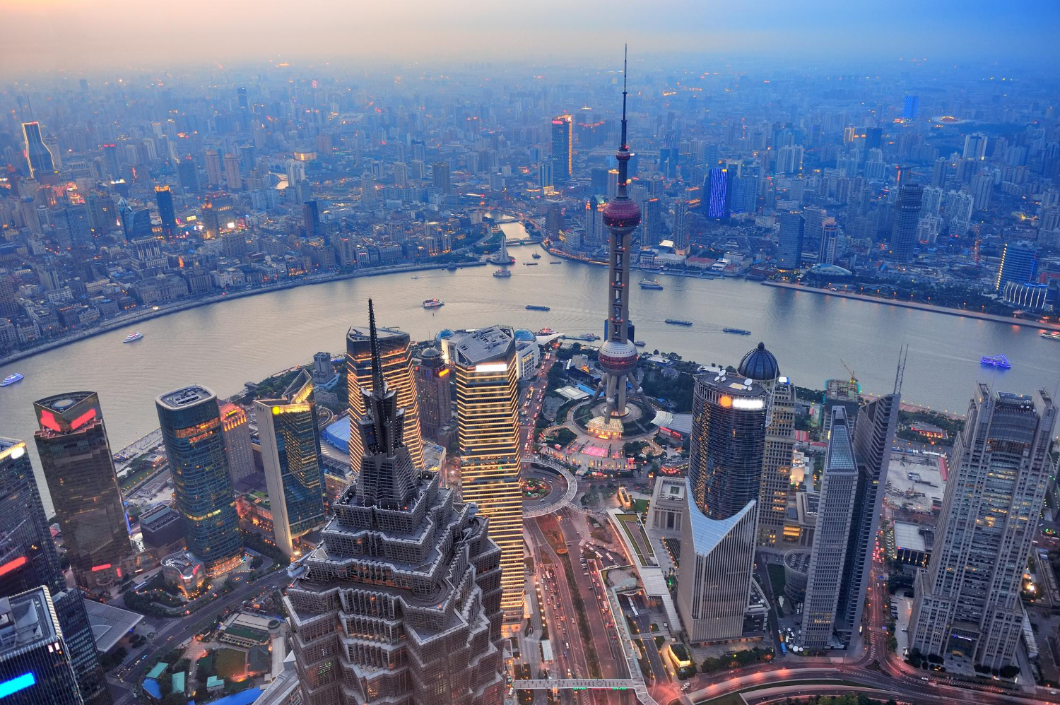 Shanghai’s skyline glows at dusk, reflecting the city’s role as a global leader in finance and innovation.